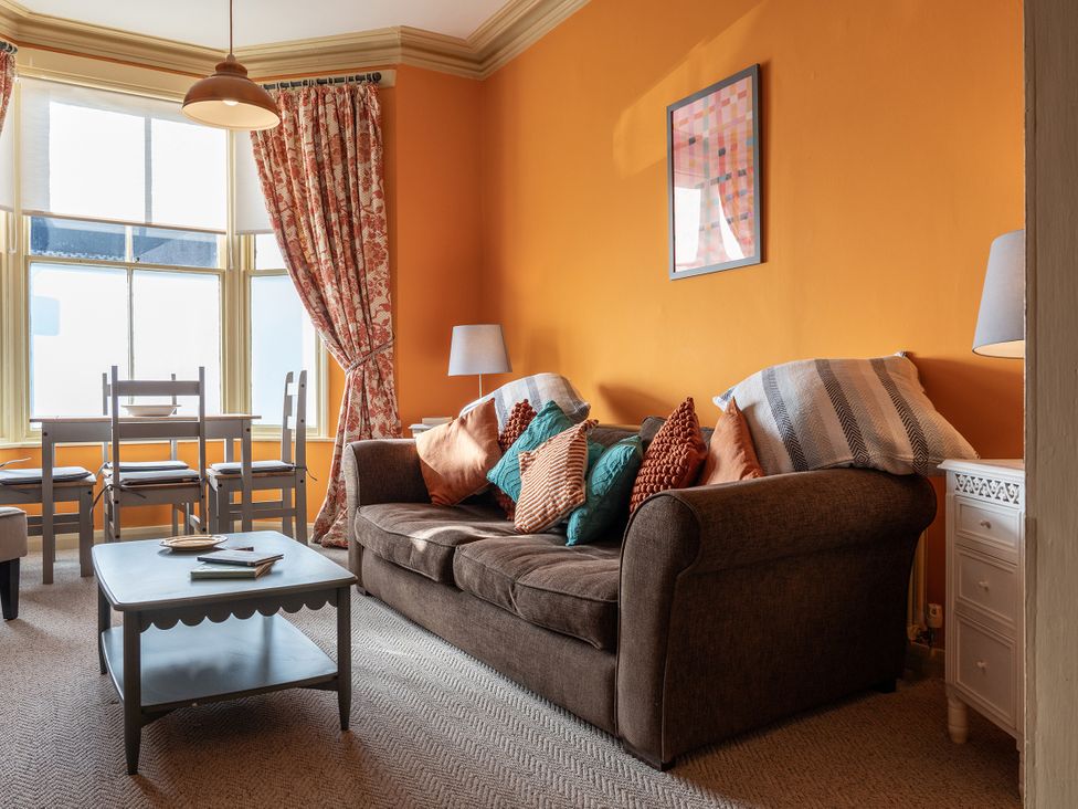 A living room with a sofa, table, and chairs at No 4 Townhouse in Bishop Auckland