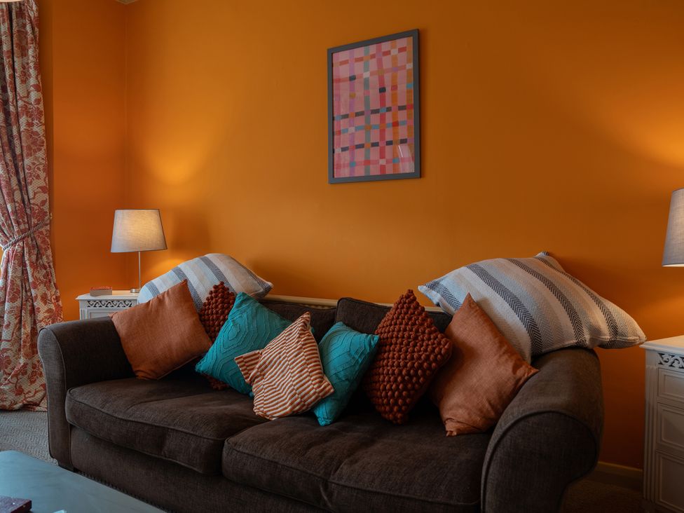 A living room with a sofa and pillows at No 4 Townhouse in Bishop Auckland