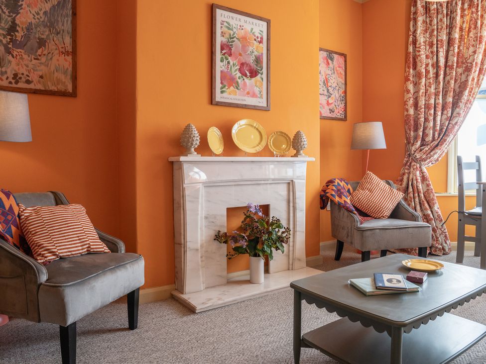 A living room with armchair and coffee table at No 4 Townhouse in Bishop Auckland