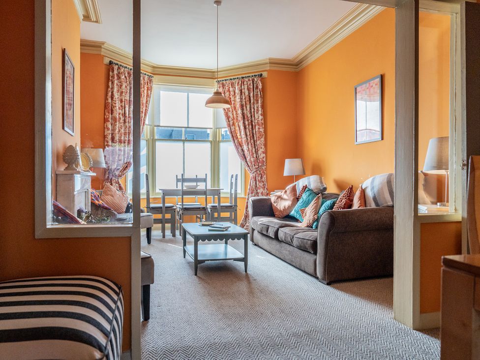 A living room with a sofa and a table at No 4 Townhouse in Bishop Auckland