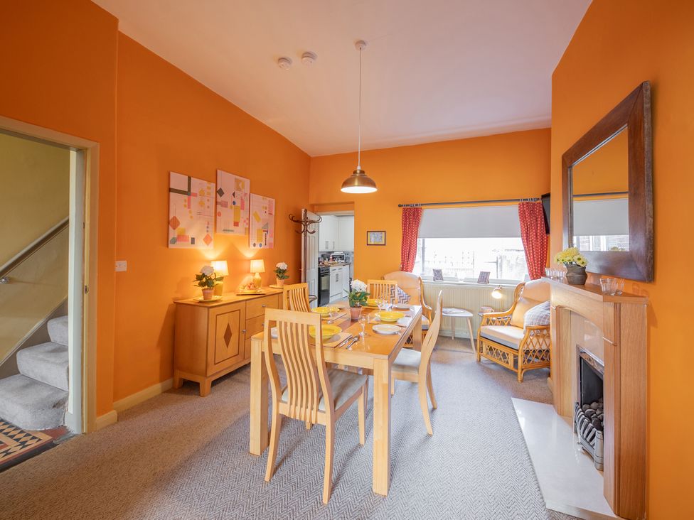 A dining room with a wooden table and chairs at No 4 Townhouse in Bishop Auckland
