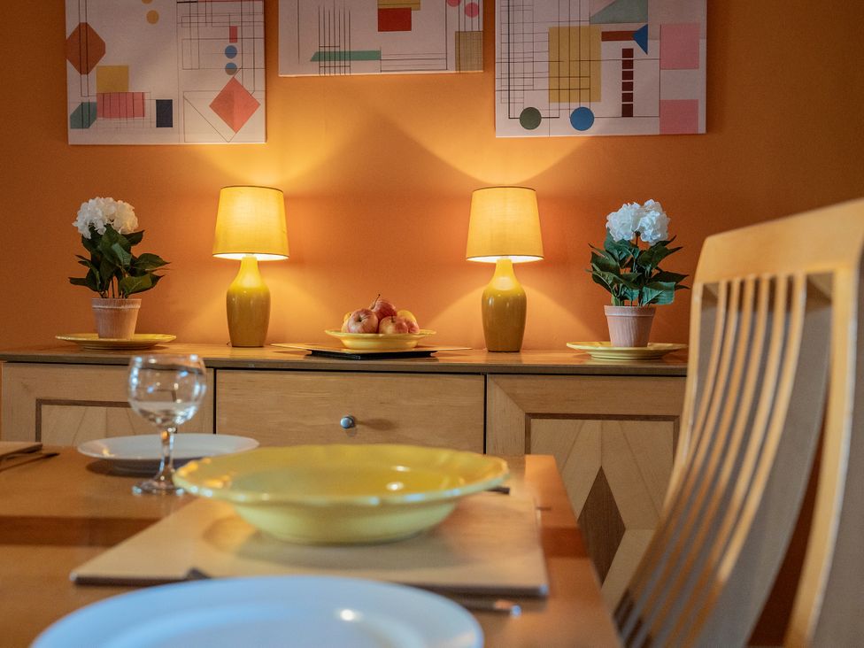 A dining room with a table set and lamps at No 4 Townhouse Bishop Auckland