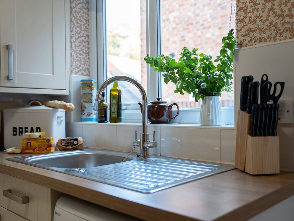 A kitchen with a sink and utensils at No 4 Townhouse in Bishop Auckland