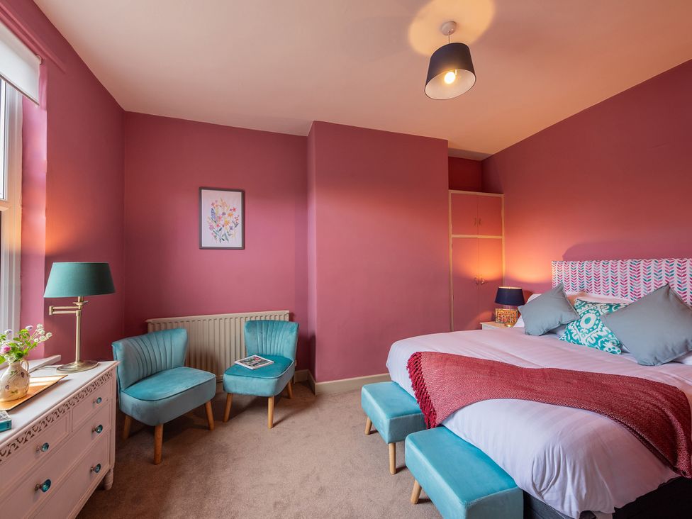 A bedroom with bed and seating area at No 4 Townhouse in Bishop Auckland
