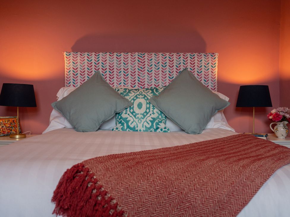 A bedroom with a bed and decorative pillows at No 4 Townhouse in Bishop Auckland