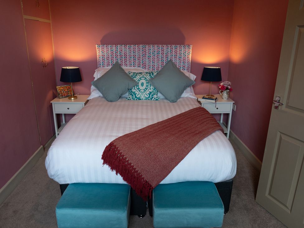 A bedroom with a bed and bedside tables at No 4 Townhouse, Bishop Auckland