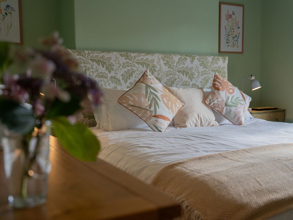A bedroom with a bed and decorative pillows at No 4 Townhouse in Bishop Auckland