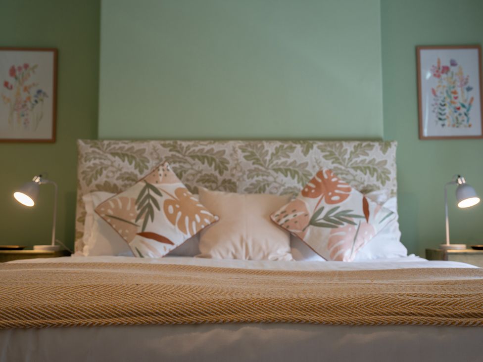 A bedroom with a bed and bedside lamps at No 4 Townhouse in Bishop Auckland