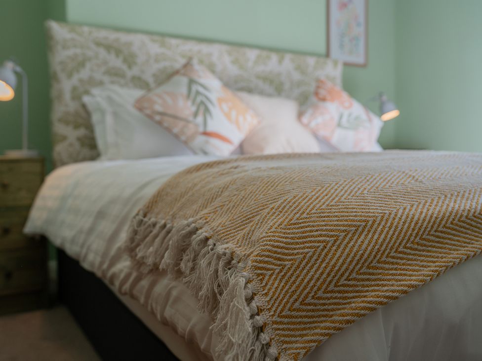A bedroom with a bed and bedside lamp at No 4 Townhouse in Bishop Auckland