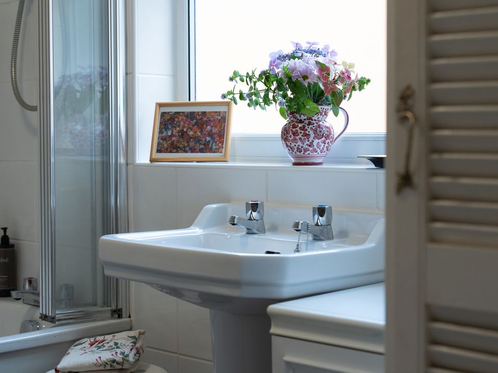 A bathroom with a sink and shower at No 4 Townhouse in Bishop Auckland