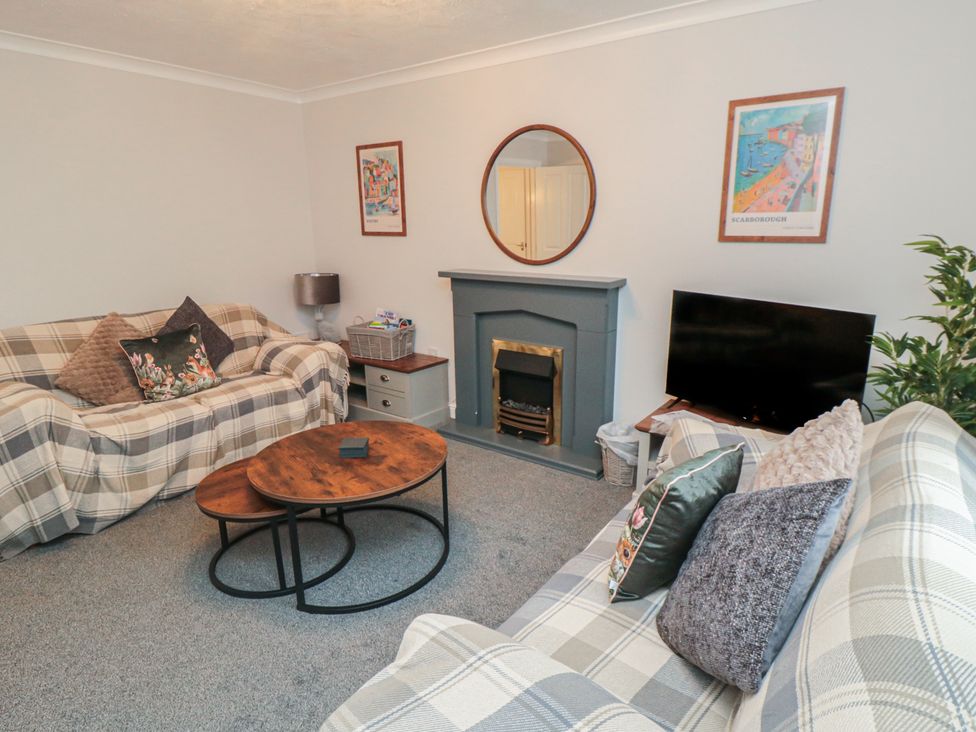 A living room with a coffee table and television at 3 Railway Terrace, Bridlington