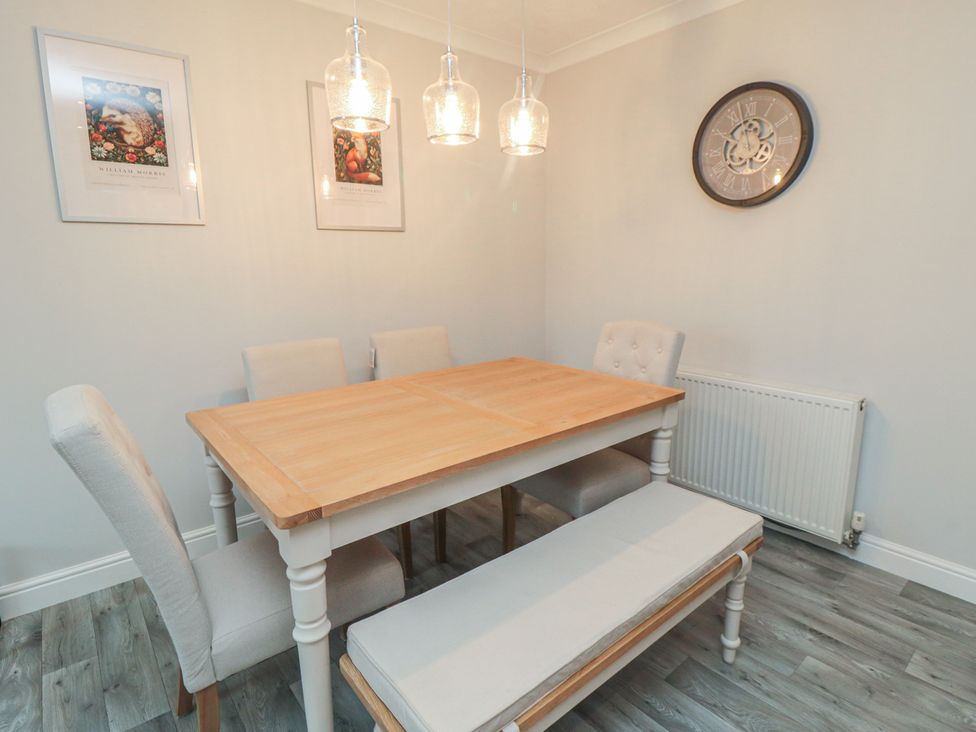 A dining room with a table and chairs at 3 Railway Terrace Bridlington