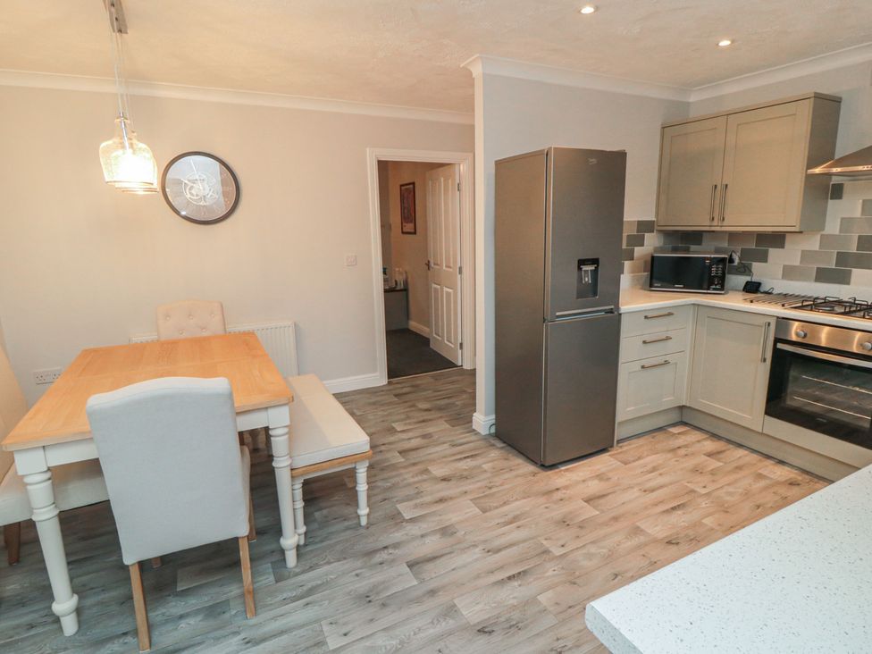 A kitchen with a dining area featuring a table and chairs at 3 Railway Terrace in Bridlington