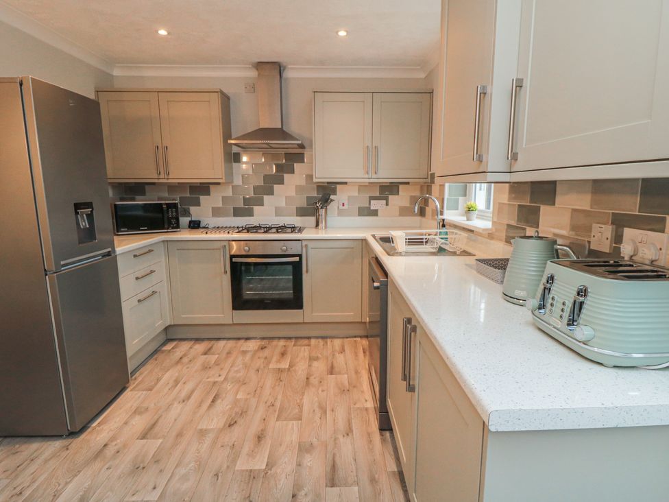 A kitchen with appliances including a refrigerator and oven at 3 Railway Terrace Bridlington