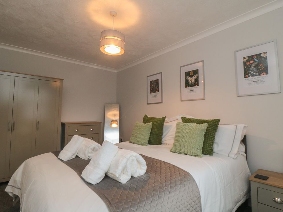 A bedroom with a bed and wardrobe at 3 Railway Terrace in Bridlington