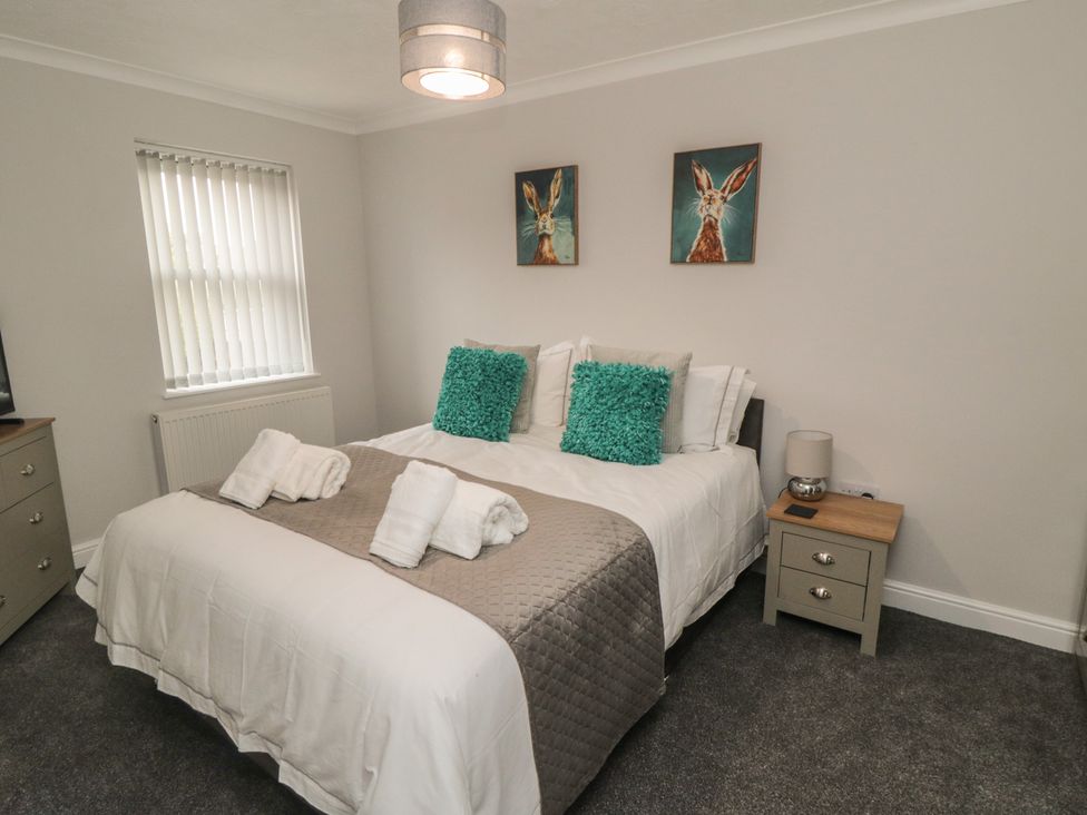 A bedroom with a bed and bedside table at 3 Railway Terrace, Bridlington