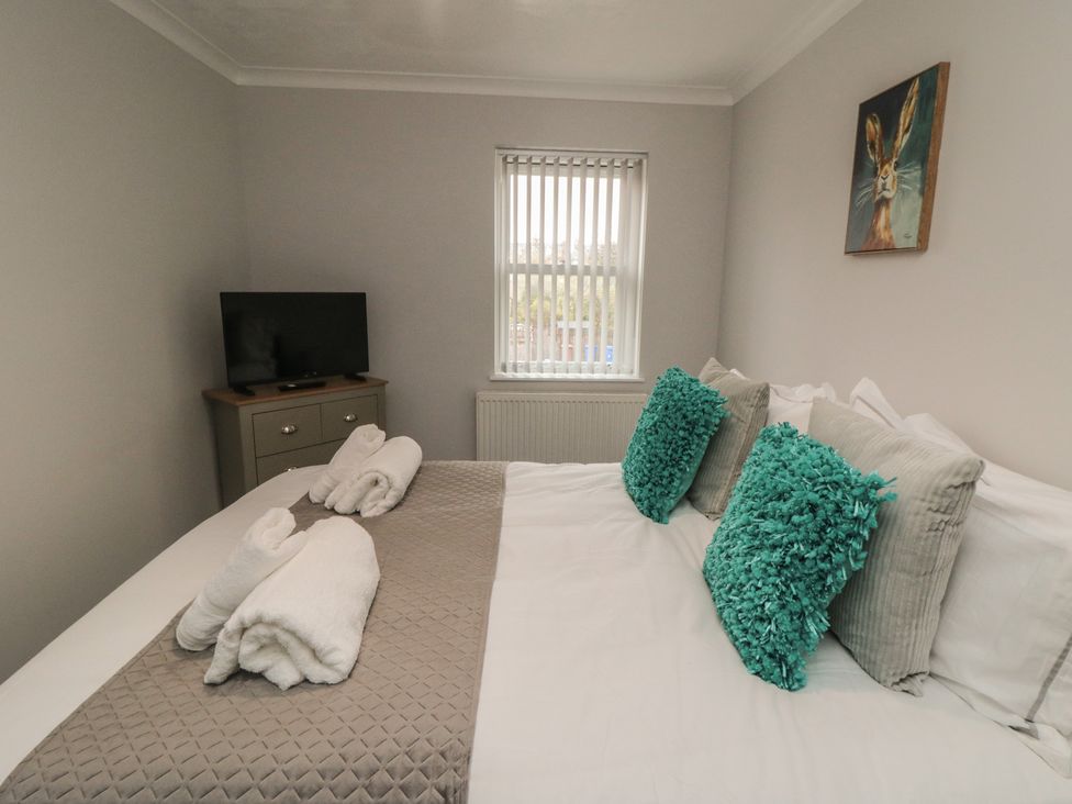 A bedroom with a bed and television at 3 Railway Terrace, Bridlington