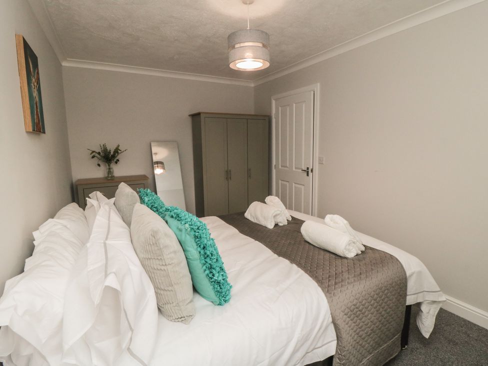 A bedroom with a bed and wardrobe at 3 Railway Terrace, Bridlington