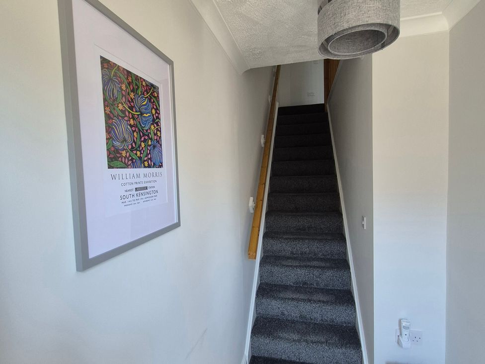 A staircase with a painting on wall at 3 Railway Terrace Bridlington