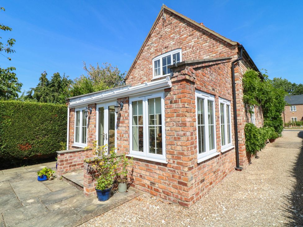 An exterior view of a brick house with windows at Wisteria House in Lincoln