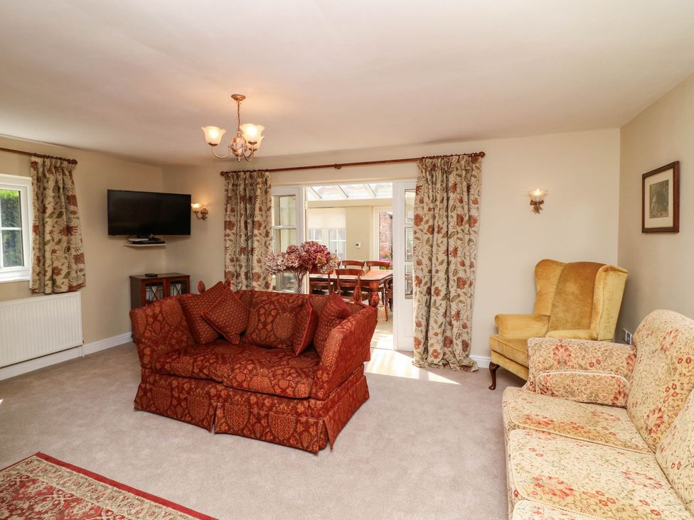 A living room with a sofa and television at Wisteria House in Lincoln