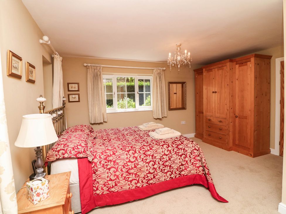 A bedroom with a bed and wardrobe at Wisteria House in Lincoln