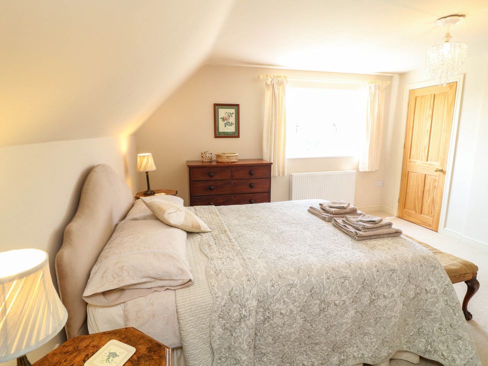 A bedroom with a bed and dresser at Wisteria House in Lincoln