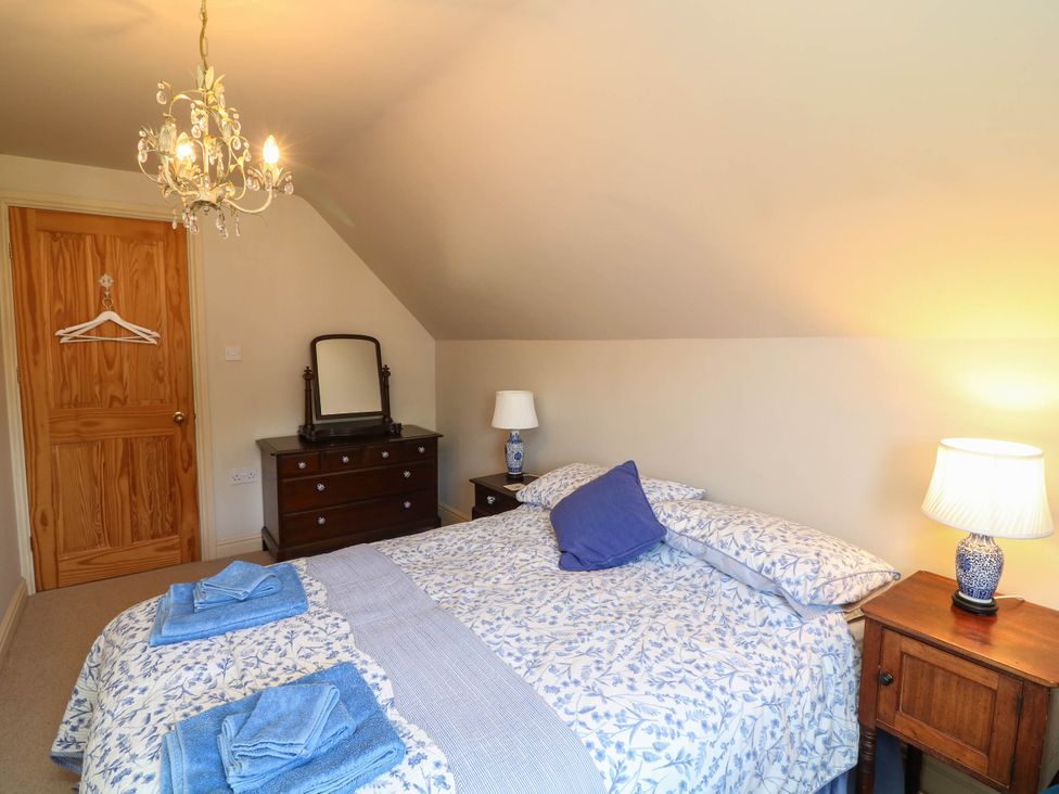 A bedroom with a bed and furniture at Wisteria House in Lincoln