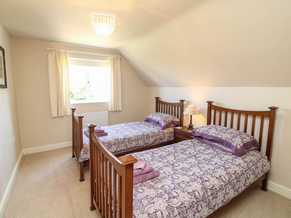 A bedroom with two beds and a window at Wisteria House in Lincoln