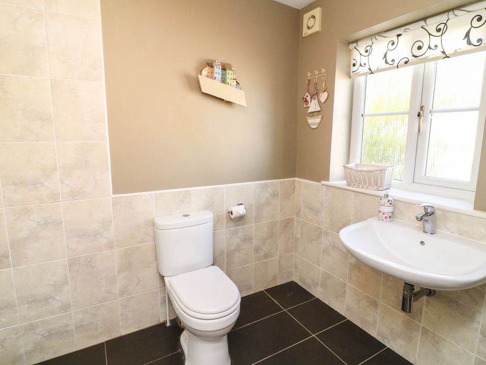 A bathroom with a toilet and sink at Wisteria House in Lincoln