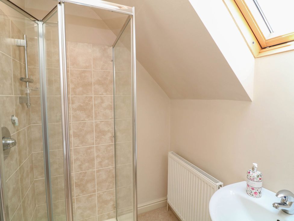 A bathroom with a shower and sink at Wisteria House Lincoln