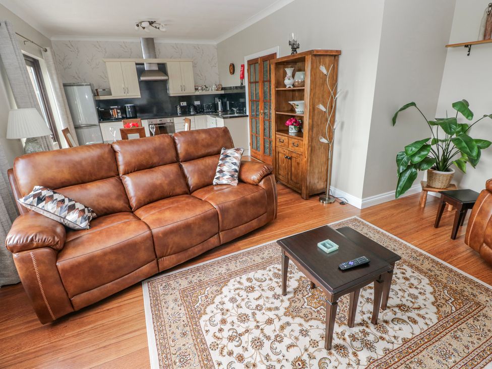 A living room with a sofa and coffee table at Harvest Hill in Letterston