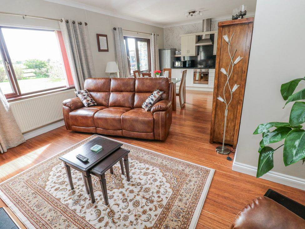 A living room with a sofa and coffee table at Harvest Hill in Letterston