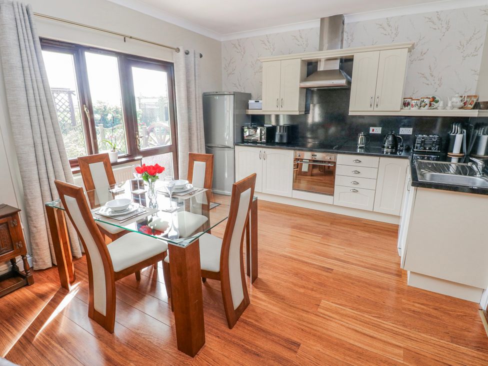 A kitchen with a dining table and chairs at Harvest Hill in Letterston