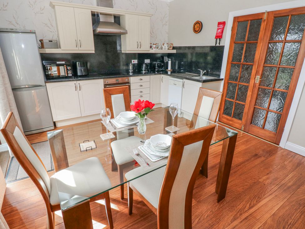 A kitchen with a dining table and chairs at Harvest Hill in Letterston