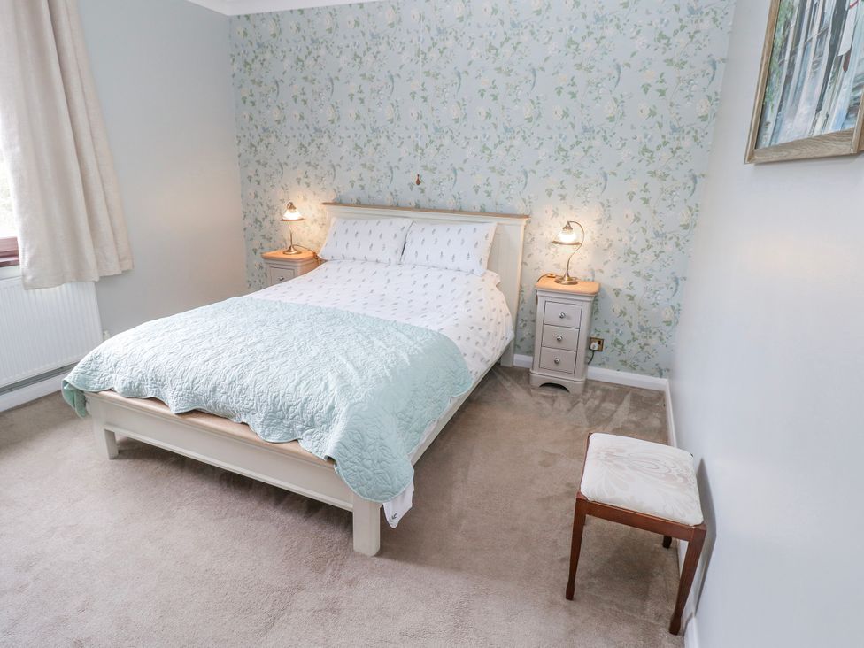 A bedroom with a bed and nightstand at Harvest Hill in Letterston