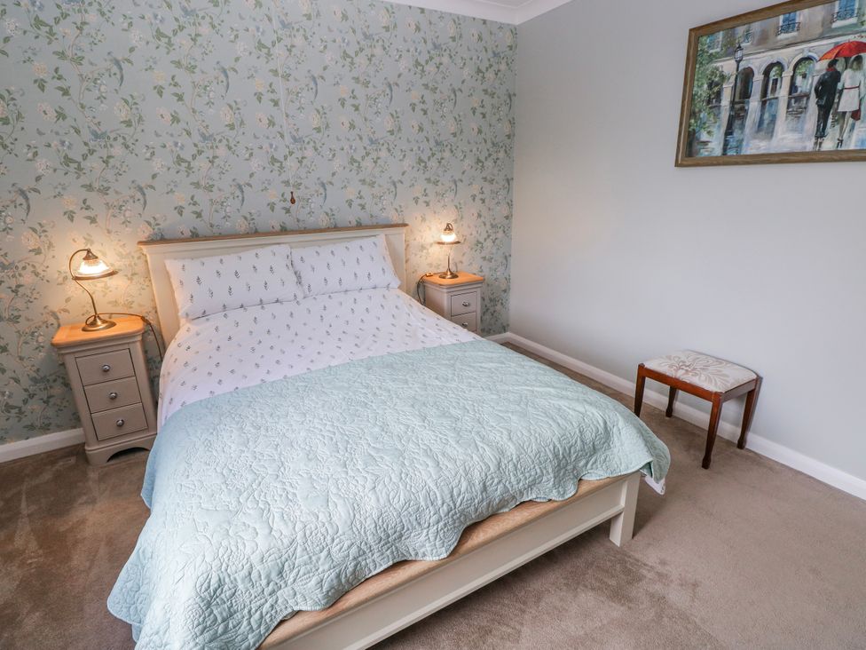 A bedroom with a bed and nightstands at Harvest Hill in Letterston