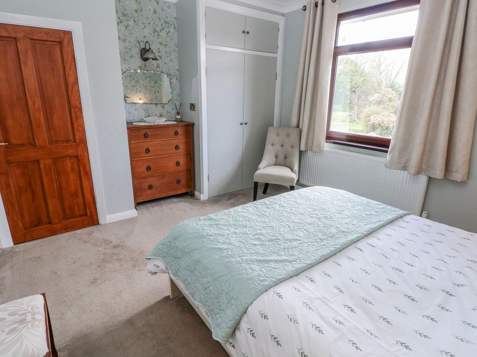 A bedroom with a bed and a dresser at Harvest Hill in Letterston