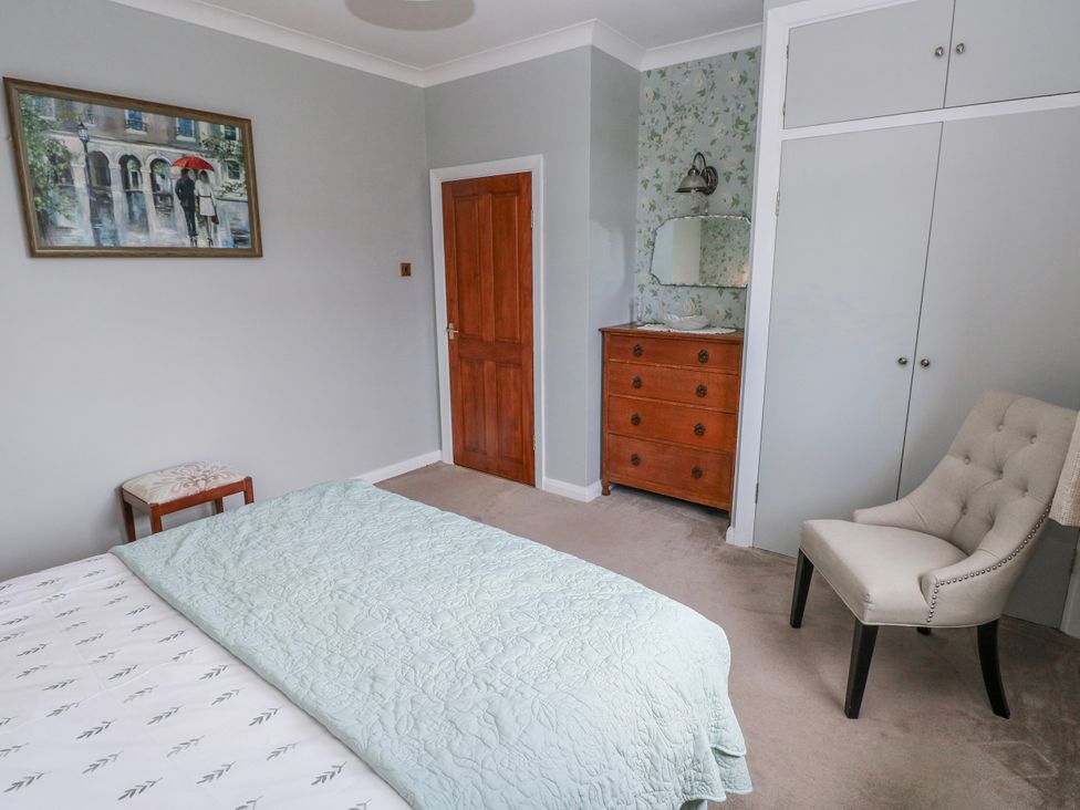 A bedroom featuring a bed and a chair at Harvest Hill in Letterston