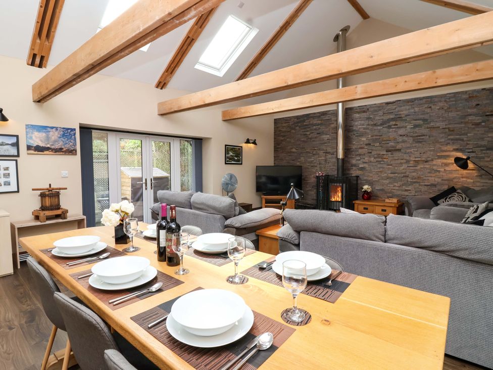 A dining area and living room in Cider Press Cottage Torpoint