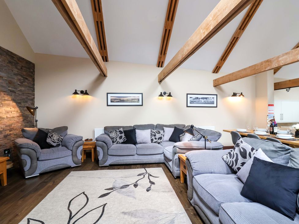 A living room with sofas and a coffee table at Cider Press Cottage in Torpoint
