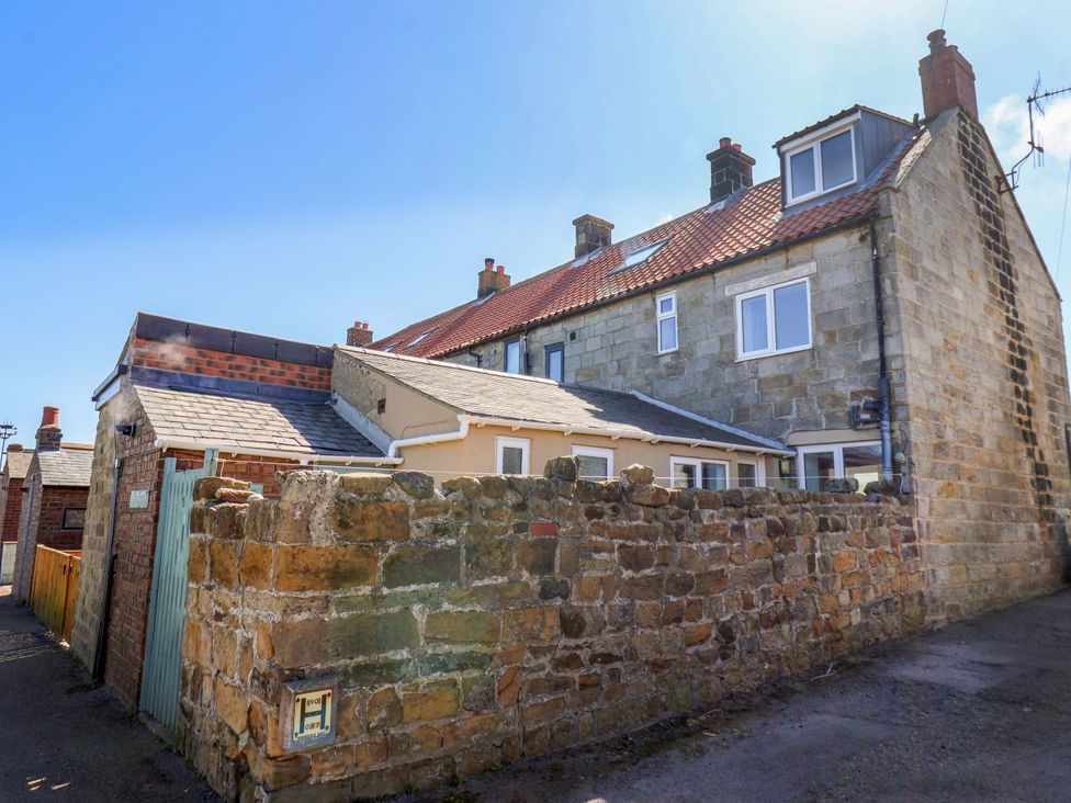 A brick and stone building with a pathway at Cozy Cottage 