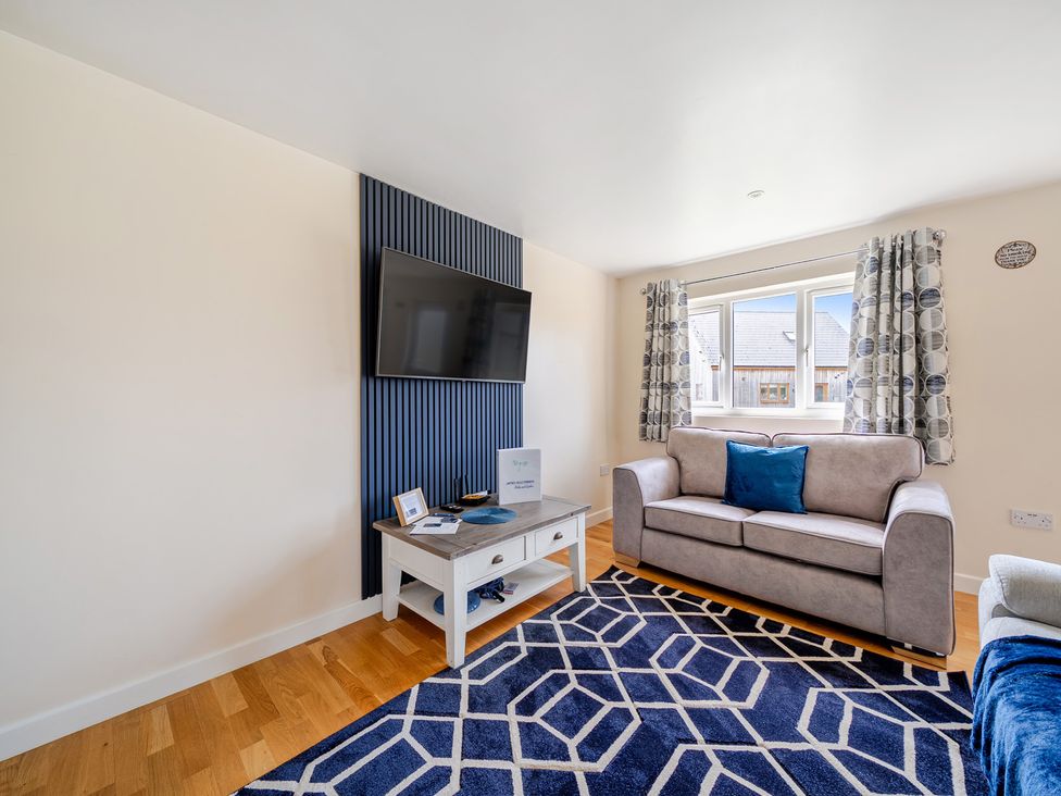 A living room with a sofa and a television at Lodge 4 Near Brigg