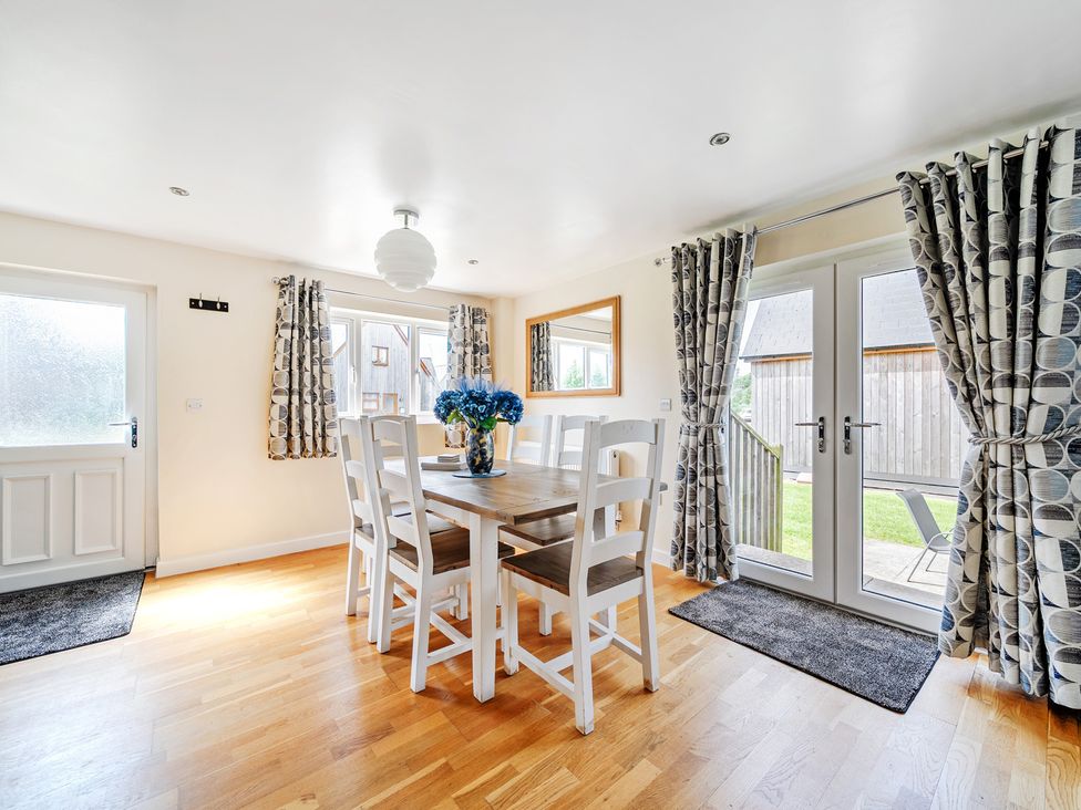 A dining room with a table and chairs at Lodge 4 Near Brigg