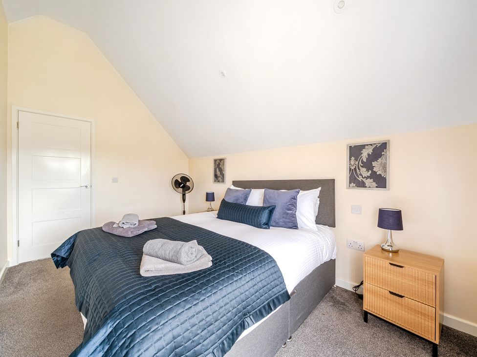 A bedroom with a bed and bedside table at Lodge 4 Near Brigg