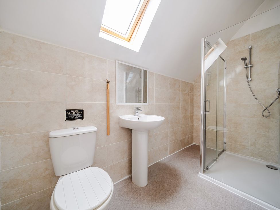 A bathroom with a shower and wash basin at Lodge 4 Near Brigg