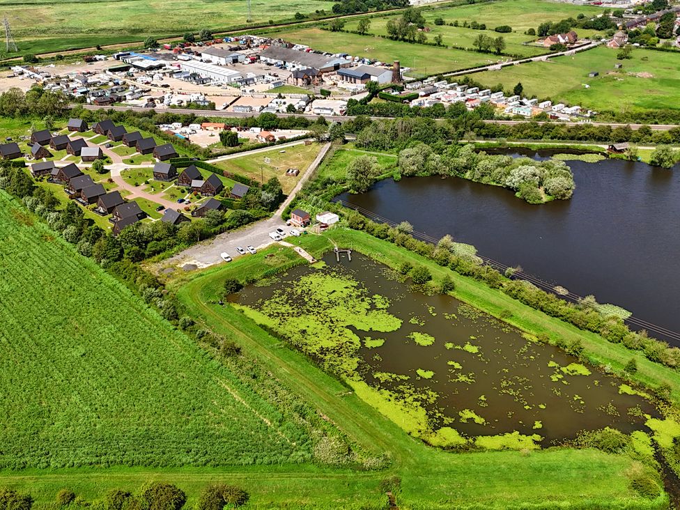 An aerial view of houses and a pond at Lodge 4 near Brigg