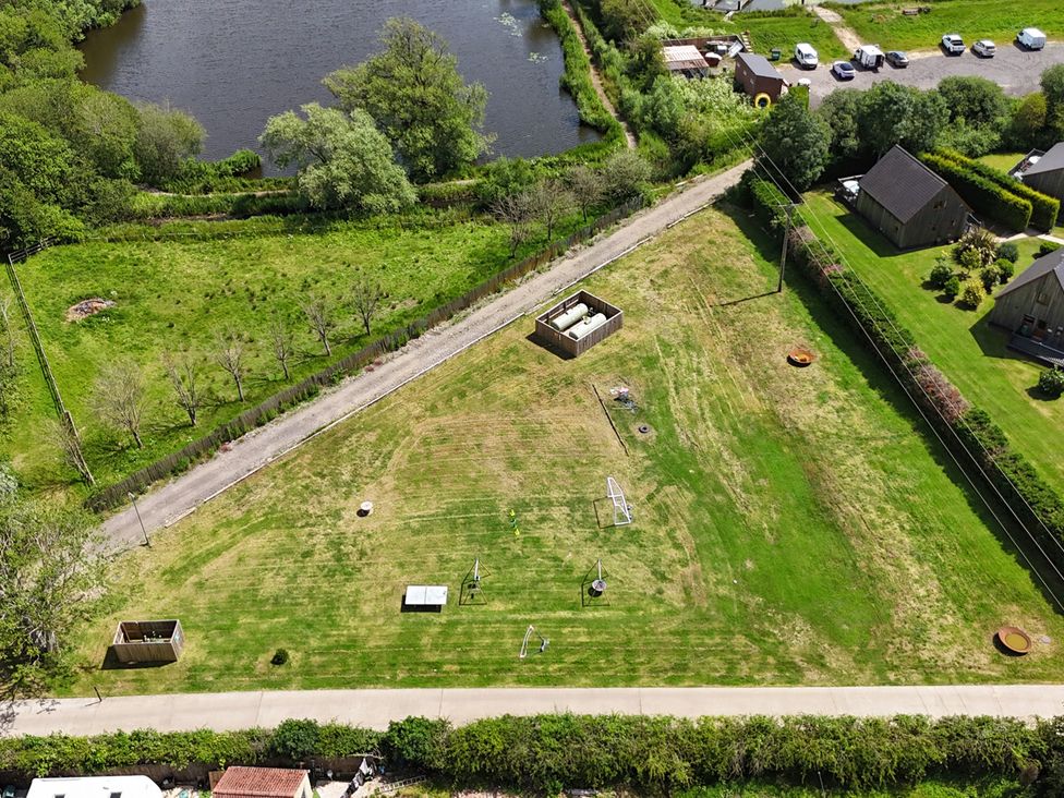 An outdoor area with grass and playground equipment at Lodge 4 near Brigg