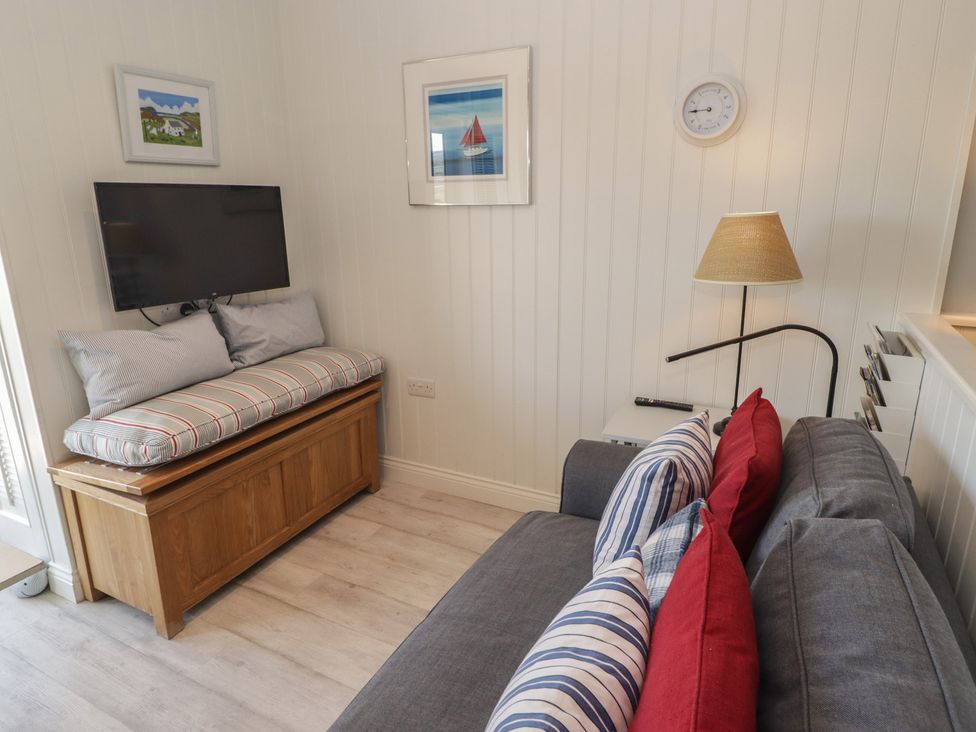 A living room with a sofa and television at The Bolthole in Newport