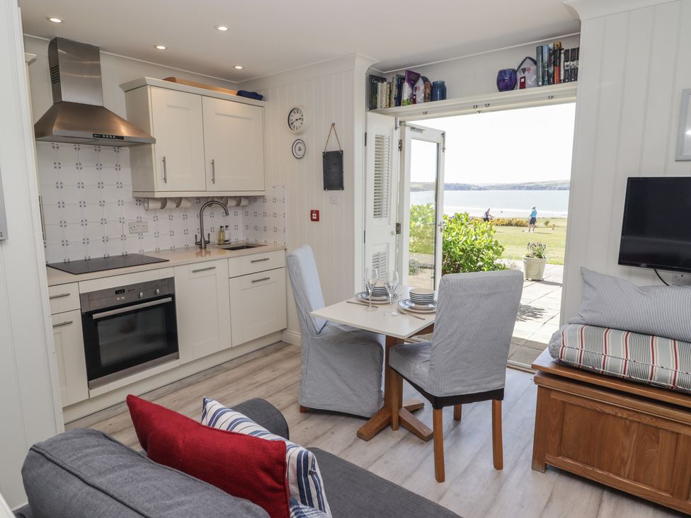 A kitchen with a table and chairs at The Bolthole in Newport